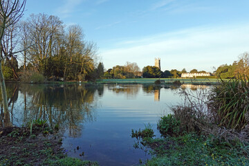 Fototapeta premium reflection of trees in the lake situated in the Cotswold town of Cirencester. Gloucestershire. UK
