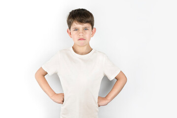 Sad angry offended boy 6-8 years old on a light background, boy is offended by his older brother...