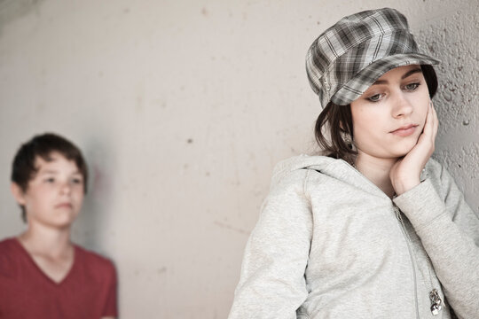 Girl and Boy Leaning on Wall