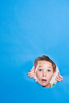 Boy Looking Through Hole