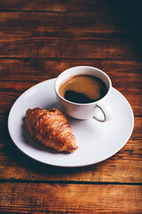 Fresh Croissant and Cup of Coffee on White Plate