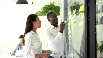 Professional trade experts planning exchange discussing together experience during collaborative meeting in office interior with glass board for informative planning, colleagues during working process