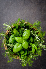Mix of fresh herbs in wicker basket - 591634716