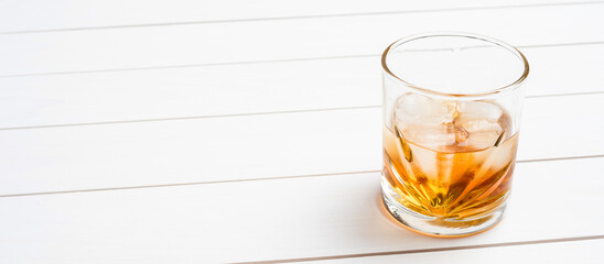 Whiskey glass on white wooden table. Close up - 591634794