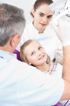 Girl with Dentist and Hygienist at Dentist's Office, Germany