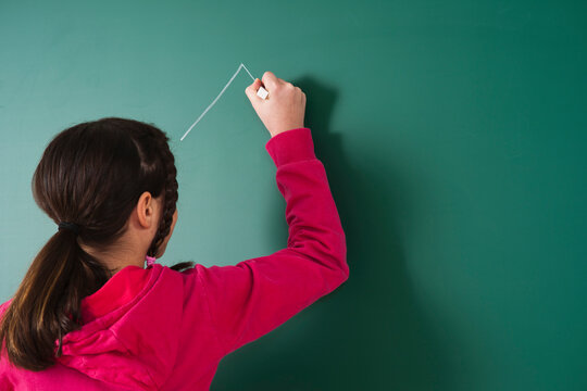 Girl Drawing on Blackboard in Classroom, Baden-Wurttemberg, Germany