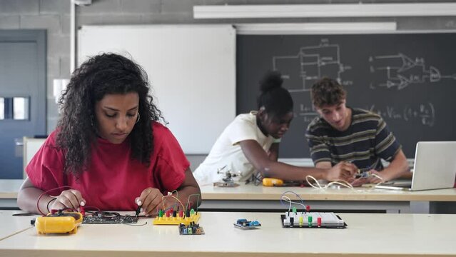Group of students learning electronics and robotics at High School College