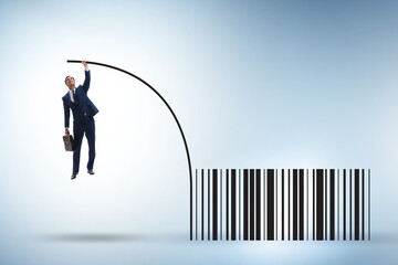 Businessman jumping over bar code in pole vaulting