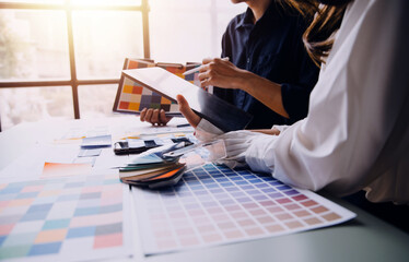 Close up ux developer and ui designer brainstorming about mobile app interface wireframe design on...