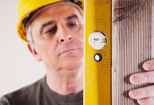 Portrait of Carpenter using Level, Studio Shot