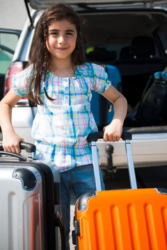 Girl Loading Luggage in Van for Vacation, Mannheim, Baden-Wurttemberg, Germany