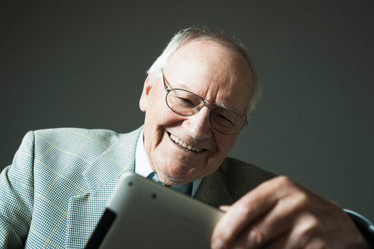 Senior Man using Tablet Computer, Studio Shot