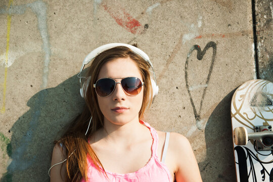 Teenager wearing Headphones in Skatepark, Feudenheim, Mannheim, Baden-Wurttemberg, Germany