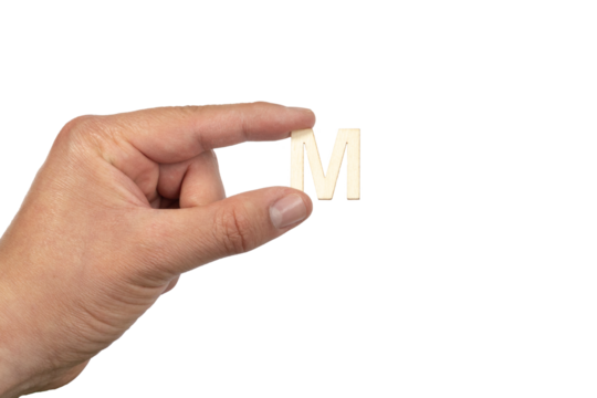 A hand holding a wooden letter m in front of a white background