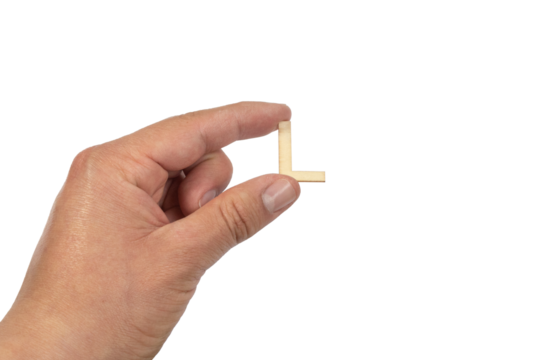 A hand holding a wooden letter l in front of a white background