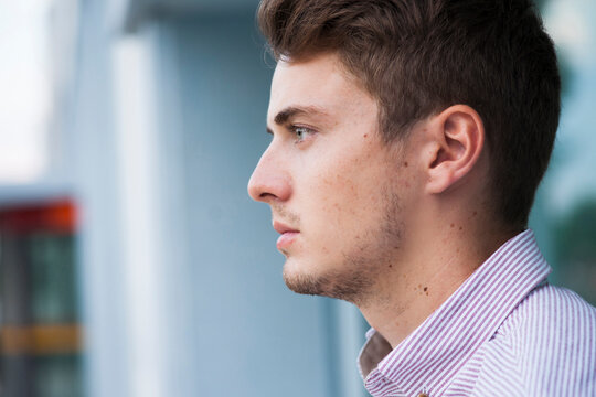 Close-up, side view portrait of young man outdoors, Germany