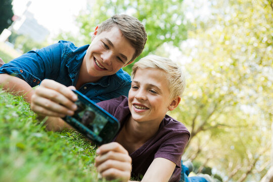 Boys taking Photo with Cell Phone Outdoors, Mannheim, Baden-Wurttemberg, Germany