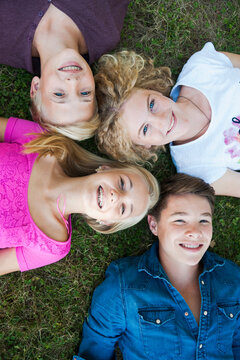 Overhead View of Teenagers Lying on Grass, Mannheim, Baden-Wurttemberg, Germany