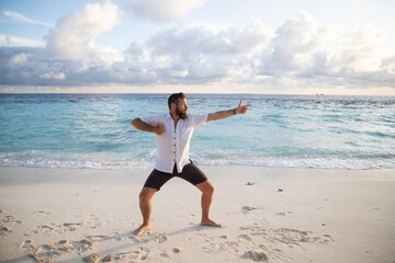Fototapeta na wymiar man practicing qigong by the sea