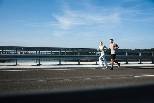 Young Couple Running, Worms, Rhineland-Palatinate, Germany
