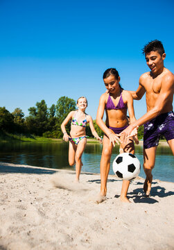 Kids Playing Soccer on Beach by Lake, Lampertheim, Hesse, Germany
