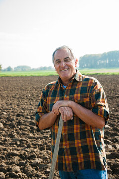 Portrait of farmer standing and working in field, Germany