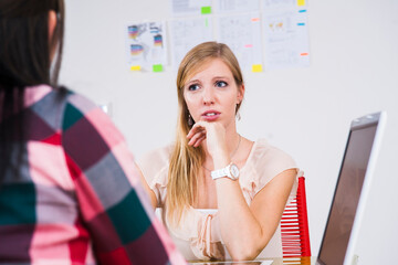 Two young businesswomen meeting and in discussion in office, Germany