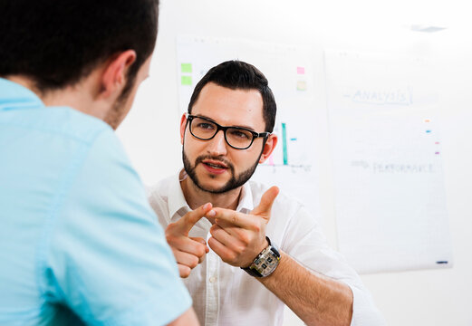Close-up of two young businessmen meeting and in discussion, Germany