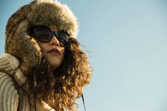 Close-up portrait of teenage girl outdoors, wearing trapper hat and sunglasses, Germany