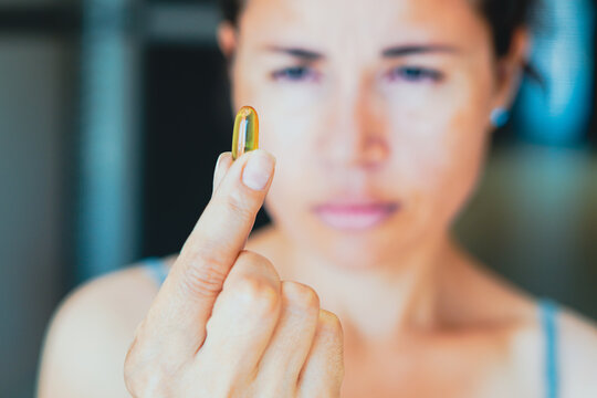 A Person Taking A Medicine Pill