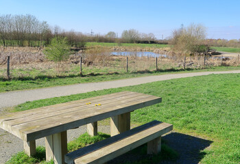 Fototapeta premium A picnic table overlooking Henhurst Lake in the North Kent countryside