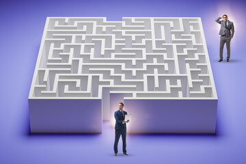 Businessman trying to find a way out of maze