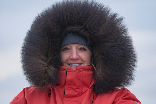 Woman dressed in a large winter parka in the extreme cold; Churchill, Manitoba, Canada
