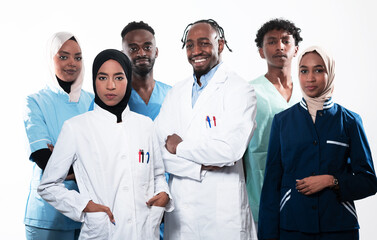 Team or group of a doctor, nurse and medical professional coworkers standing together. Portrait of diverse healthcare workers looking confident. Middle Eastern and African, Muslim medical team. 