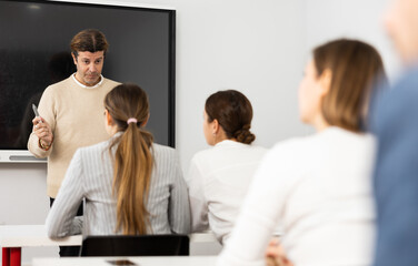 Knowledgeable professor explaining subject to classroom full of students