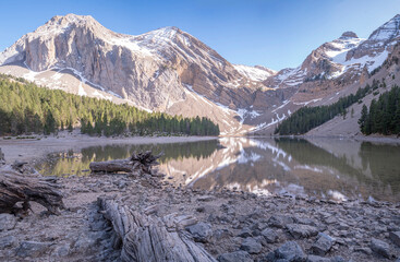 landscape view of the mountain lake of ibón del plan in the Pyrenees at sunset, Spain