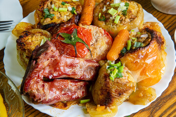 Baked bell peppers stuffed with vegetable and meat...food on wooden table...delicious Mediteranian dish...