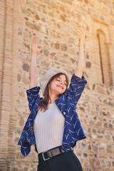 young girl standing with arms up with happy expression