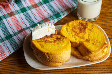 Fried bread with eggs and milk yogurt on a wooden table...