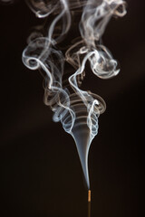 white smoke in interesting vortex pattern on black background. illustration for smoking, air...