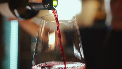 bartender pouring red luxury wine in wineglass, closeup macro - Powered by Adobe