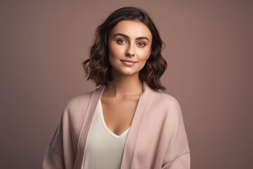 Fototapeta premium Portrait of a beautiful young brunette woman in a pink coat.