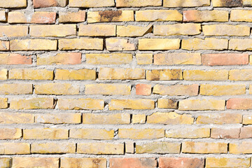 Obraz premium background consisting of yellow or gold colored brick wall