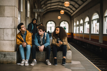 Fototapeta na wymiar A group of friends waiting at train or subway station. Generative ai.