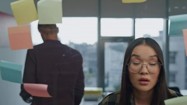 Angry man tearing sticker at office closeup. Team arguing at strategy board room