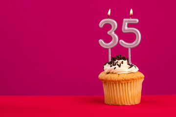 Candle number 35 - Cake birthday in rhodamine red background