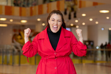 Woman triumphantly raises fists in celebration with pure joy