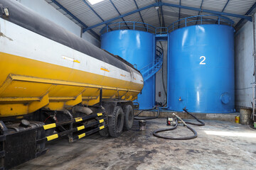 road tankers and storage tanks.  Process of loading vegetable oil from vertical tank containers to...