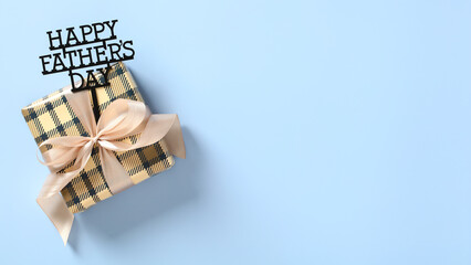 Vintage gift box with sign Happy Father's Day on blue background. Fathers Day banner template with...