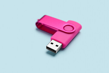 Pink USB flash drive on color background